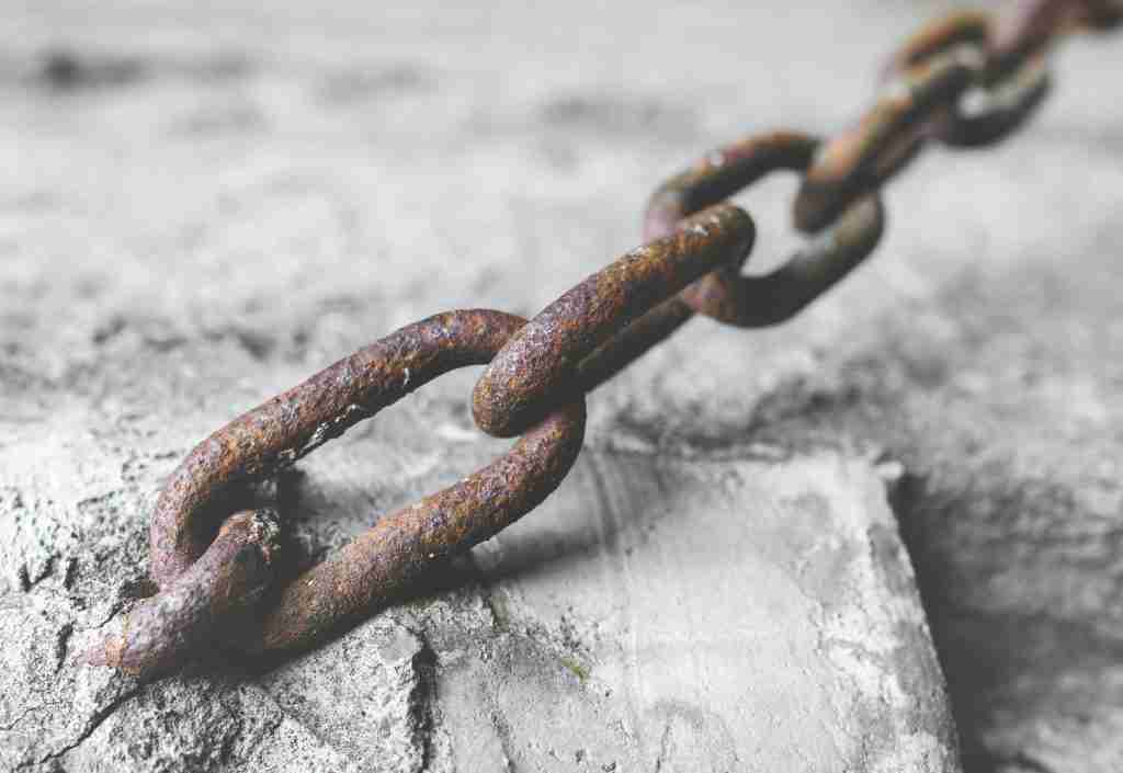 Rusty chain in the cement